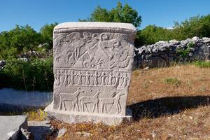 Stecci Medieval Tombstones Graveyards in Brotnice, Croatia. Historic place of interest. The tombstones feature a wide range of decorative motifs and inscriptions. photo