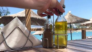 Olive oil mixed with herbs pouring on a transparent surface over camera. Shot in slow motion fresh tomato salad with microgreens and olive oil. olive oil pouring, organic vegetables, vegan diet video