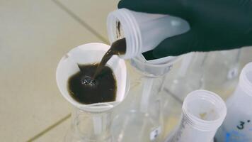 Agrochemical Analyst pouring Soil Samples Mixed with Extracts into Lab Filters. Soil Analysis within Research Facility. Biochemical Process in Laboratory video