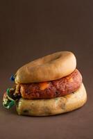 Traditional Portuguese sausages - linguica, farinheira, and alheira - displayed on a rustic brown background. photo