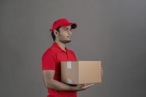 Indian delivery man in red shirt quarantine hero. photo