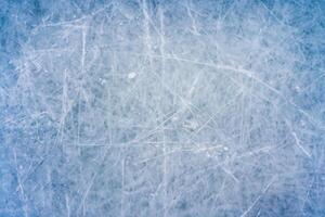 Icy Canvas, Abstract Patterns of Skating and Hockey Marks on Blue Rink Surface Texture. photo