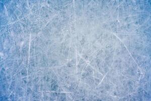 Icy Canvas, Abstract Patterns of Skating and Hockey Marks on Blue Rink Surface Texture. photo