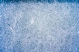 Icy Canvas, Abstract Patterns of Skating and Hockey Marks on Blue Rink Surface Texture. photo