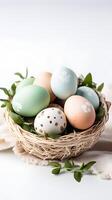 A basket of colorful eggs with copyspace on a white background. Easter egg concept, Spring holiday photo