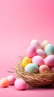 A basket of colorful eggs with copyspace on a pink background. Easter egg concept, Spring holiday photo