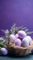 A basket of colorful eggs with copyspace on a purple background. Easter egg concept, Spring holiday photo