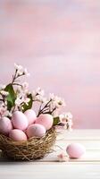 A basket of colorful eggs with copyspace on a pink background. Easter egg concept, Spring holiday photo