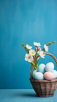 A basket of colorful eggs with copyspace on a blue background. Easter egg concept, Spring holiday photo