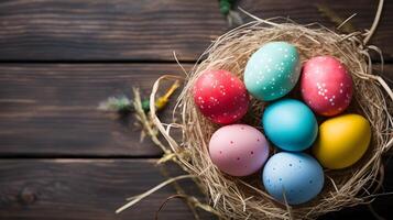 A basket of colorful eggs with copyspace on wooden floor. Easter egg concept, Spring holiday photo