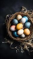 A basket of colorful eggs with copyspace on a black background. Easter egg concept, Spring holiday photo