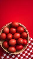 A basket of colorful eggs with copyspace on a red background. Easter egg concept, Spring holiday photo