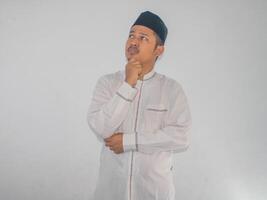 Moslem Asian man serious expression when thinking about something photo