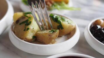 fork pick boiled potatoes on breakfast table video