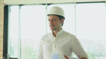 Engineer developer in helmet inspecting building. Builder constructor specialist. Civil engineer architect construction site video