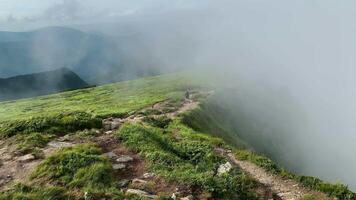 Man walks along the mountains to the top. Travel concept active people on the way to victory move forward close up video