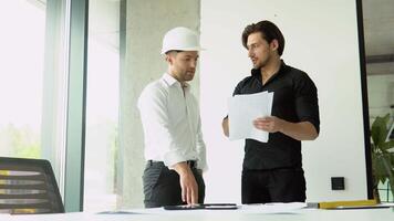 Two civil engineer handshake after mega project done. Handshake engineer sketching a construction project concept video