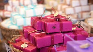 woman choosing a colorful natural soap bar selling at shop video