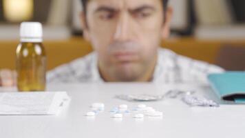 Unhappy man using medication. video