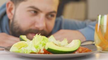 Man on diet smiling at salad. video