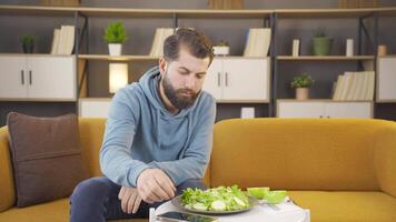 Man on diet eating green salad. video