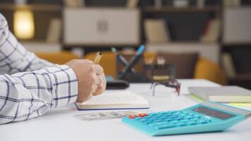 Man doing home economics calculations. video