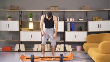 Young, happy and muscular athlete lifts dumbbells. video