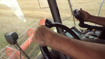 view from the cabin of the combine, dirty hands on the steering video