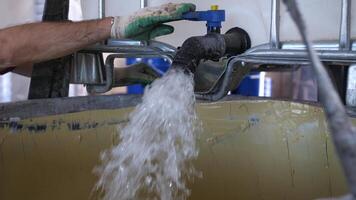 toxic flammable liquid is poured from a technical tap into industrial container video