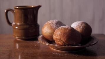 Sprinkling donuts with icing sugar for Hanukkah in December. This is a traditional Jewish food close up in 4k without people video