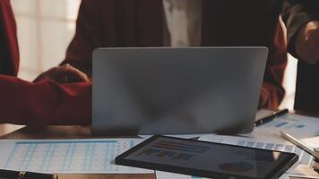 Financial analysts analyze business financial reports on a digital tablet planning investment project during a discussion at a meeting of corporate showing the results of their successful teamwork. video