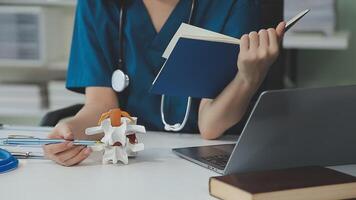 Gynecologist doctor points to model of female reproductive system in clinic video