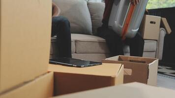 A couple of men and women talking while packing things into cardboard boxes video