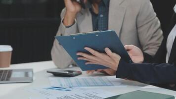 Financial analysts analyze business financial reports on a digital tablet planning investment project during a discussion at a meeting of corporate showing the results of their successful teamwork. video