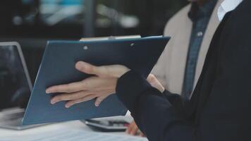 Financial analysts analyze business financial reports on a digital tablet planning investment project during a discussion at a meeting of corporate showing the results of their successful teamwork. video