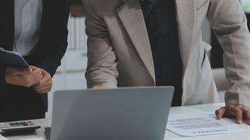 Financial analysts analyze business financial reports on a digital tablet planning investment project during a discussion at a meeting of corporate showing the results of their successful teamwork. video