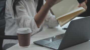 Young architect work project. Photo woman working with new startup project in modern loft. Generic design notebook on wood table. Horizontal, film effect video