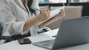 Young architect work project. Photo woman working with new startup project in modern loft. Generic design notebook on wood table. Horizontal, film effect video