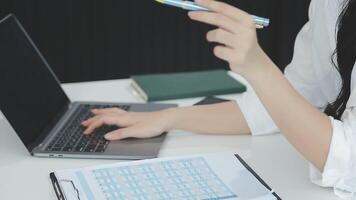 Young architect work project. Photo woman working with new startup project in modern loft. Generic design notebook on wood table. Horizontal, film effect video