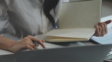 Young architect work project. Photo woman working with new startup project in modern loft. Generic design notebook on wood table. Horizontal, film effect video