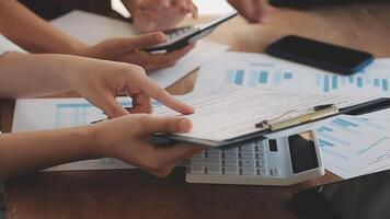 Financial analysts analyze business financial reports on a digital tablet planning investment project during a discussion at a meeting of corporate showing the results of their successful teamwork. video