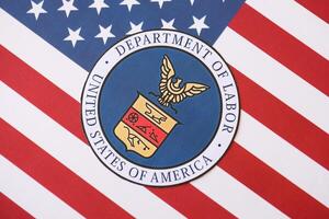 KYIV, UKRAINE - MARCH 9, 2024 US Department of Labor seal on United States of America flag photo