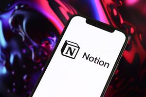 KYIV, UKRAINE - MARCH 17, 2024 Notion logo on iPhone display screen with background of artificial intelligence futuristic ai generated image photo