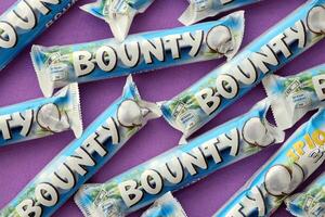 KYIV, UKRAINE - OCTOBER 31, 2023 Bounty chocolate bars with cocoa flavor filling. Bounty chocolate bar is a brand of American Mars Inc photo