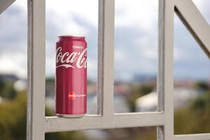 KYIV, UKRAINE - 4 MAY, 2023 Coca cola soft drink brand tin can with cherry flavour photo