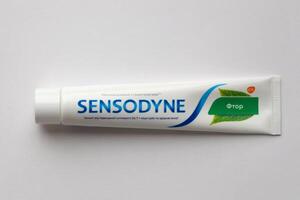 KYIV, UKRAINE - MAY 4, 2022 Sensodyne fluorine or fluor is a daily fluoride toothpaste photo