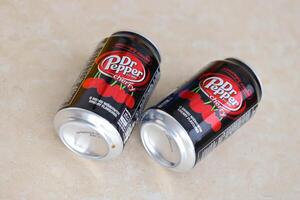 KYIV, UKRAINE - 4 MAY, 2023 Dr Pepper cherry drink black cans photo