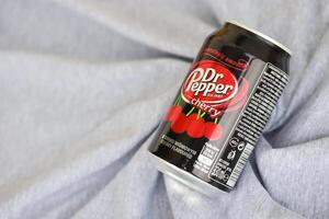 KYIV, UKRAINE - 4 MAY, 2023 Dr Pepper cherry drink black cans photo