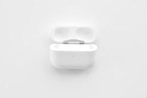 KYIV, UKRAINE - 4 MAY, 2023 Apple AirPods Pro on a white background. Wireless headphones in a charging case photo