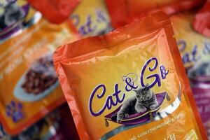 KYIV, UKRAINE - 4 MAY, 2023 Cat and Go adult cat food with various tastes in orange packages photo